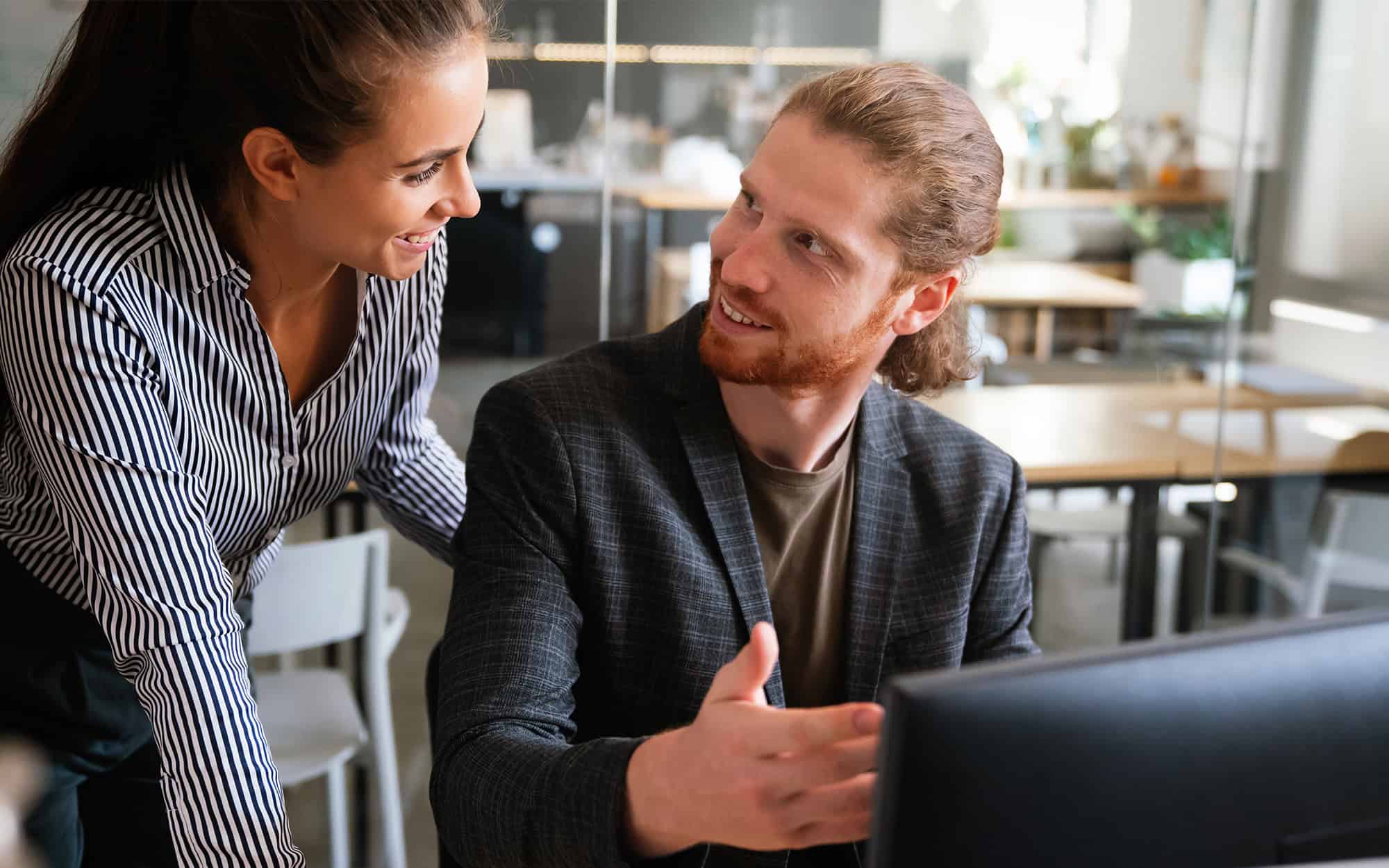 Front View Of Two It Professionals Talking About Tech At Computer